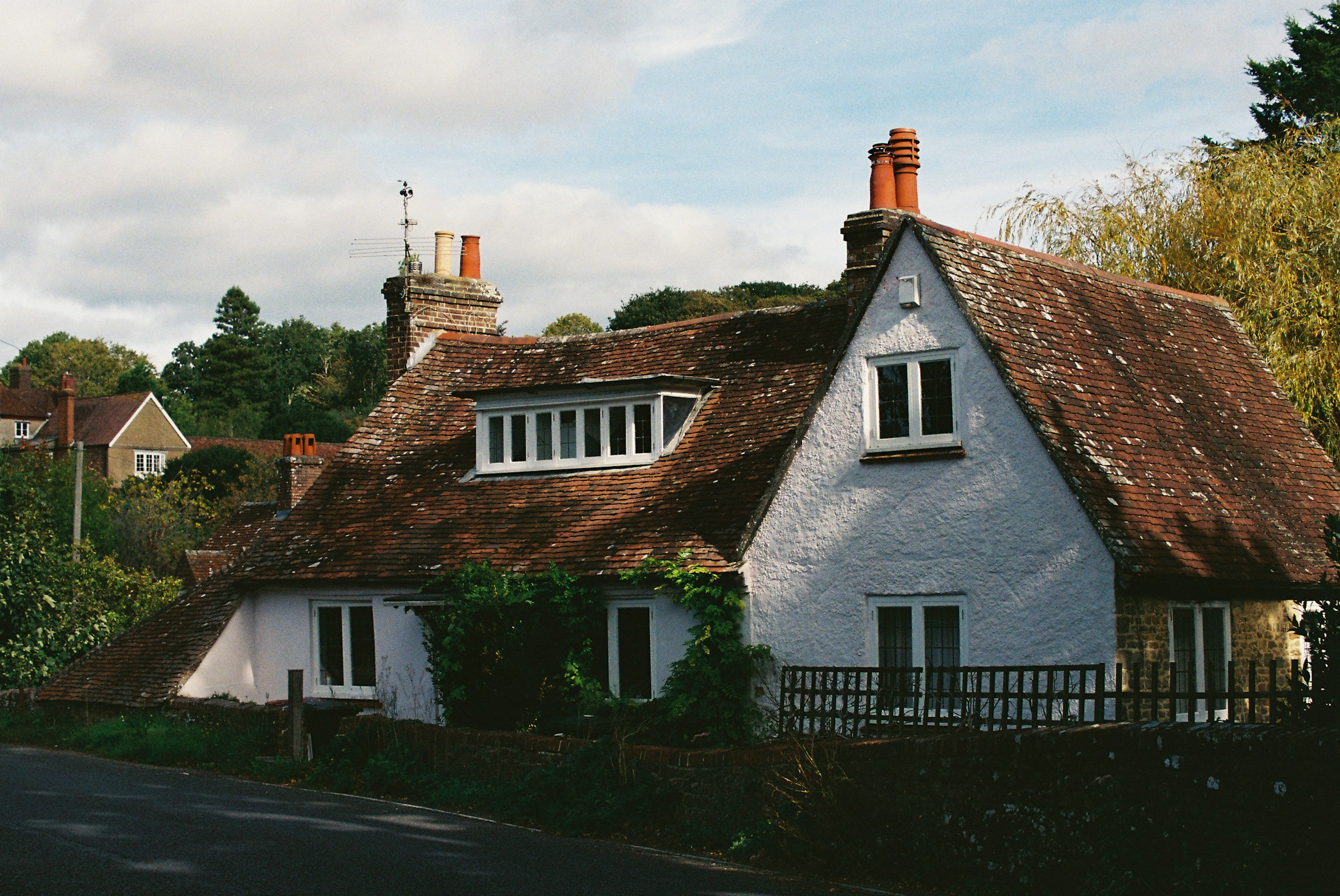 White cottage with a weathered tiled roof.